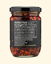 Jar of chili flakes with nutrition facts label on a white background